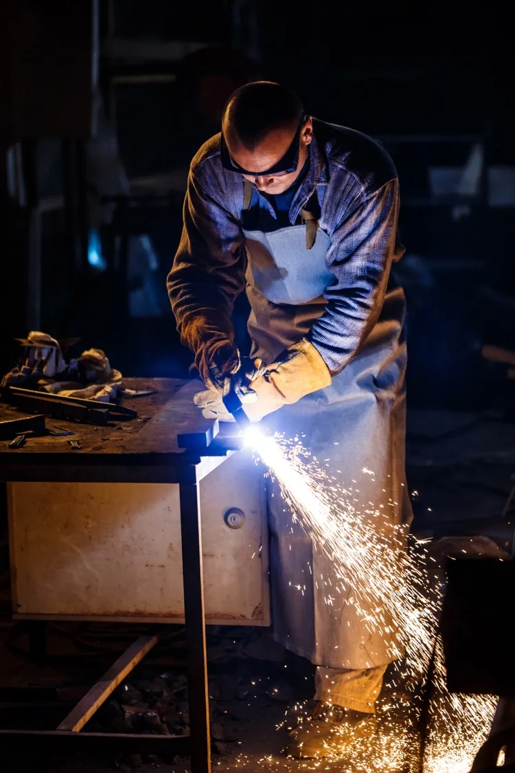 Plasma cutting metal at industrial plant
