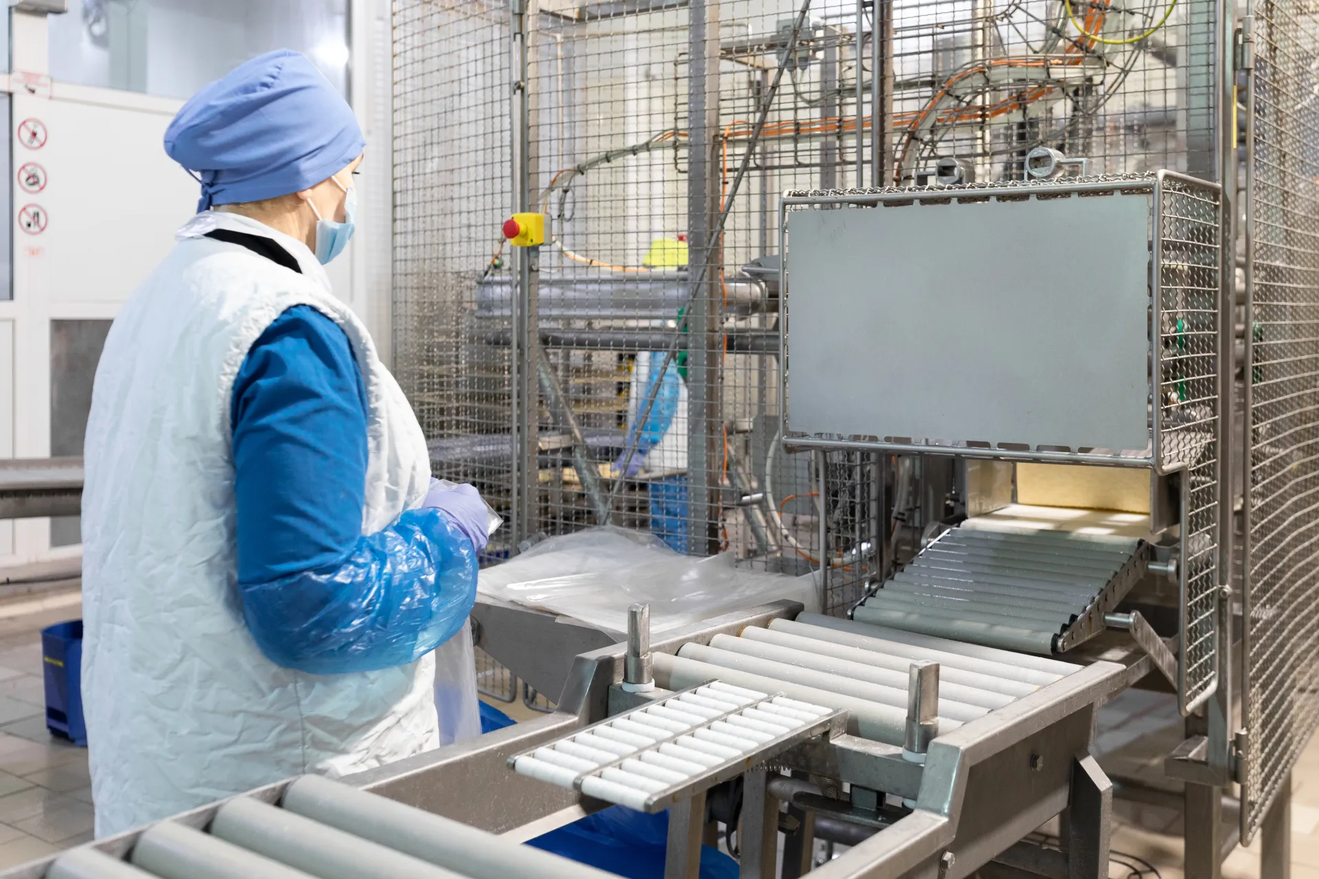 Worker setting up production line at food processing plant